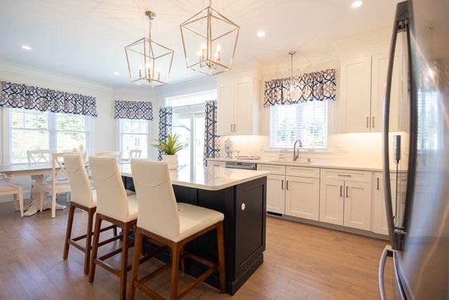 Gourmet kitchen with quartz island and pendant lighting in a 55+ active adult condominium at Trailside Estates Rochester MA