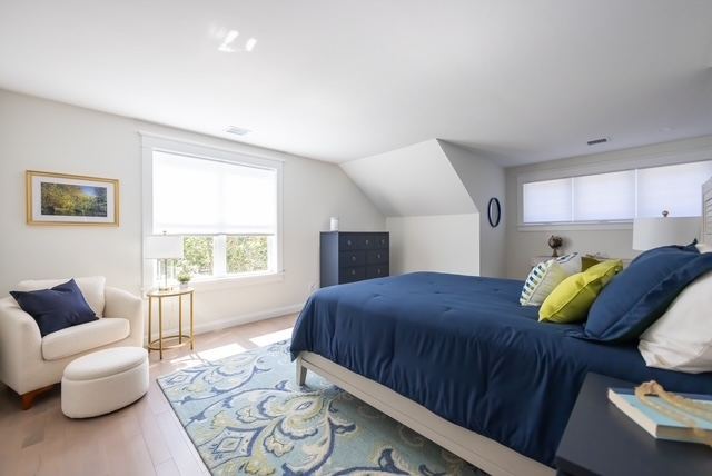 Second-floor guest bedroom with natural light at a 55+ active adult condominium at Trailside Estates